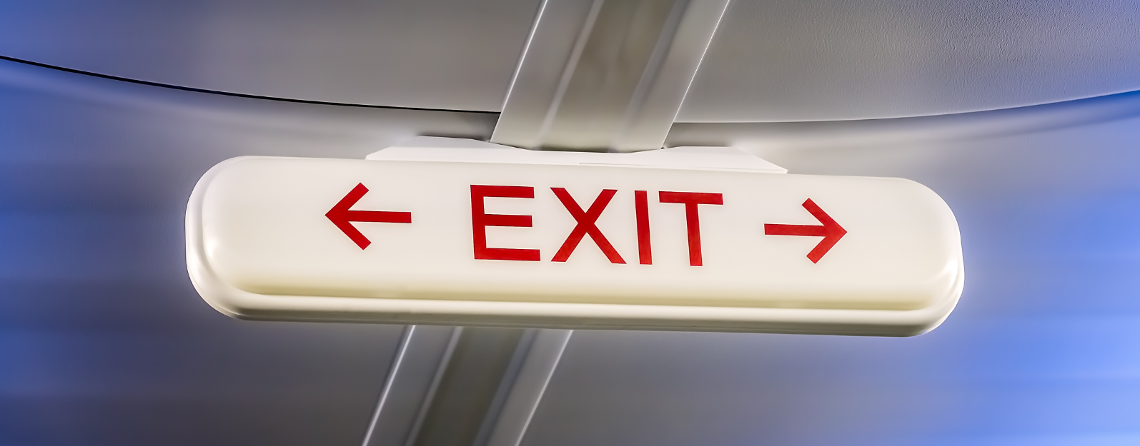 exit sign above exit row on a plane